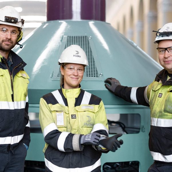 Hydro-ansatte foran en turbin i et vannkraftverk — den fornybare kraften REDUXA produseres på